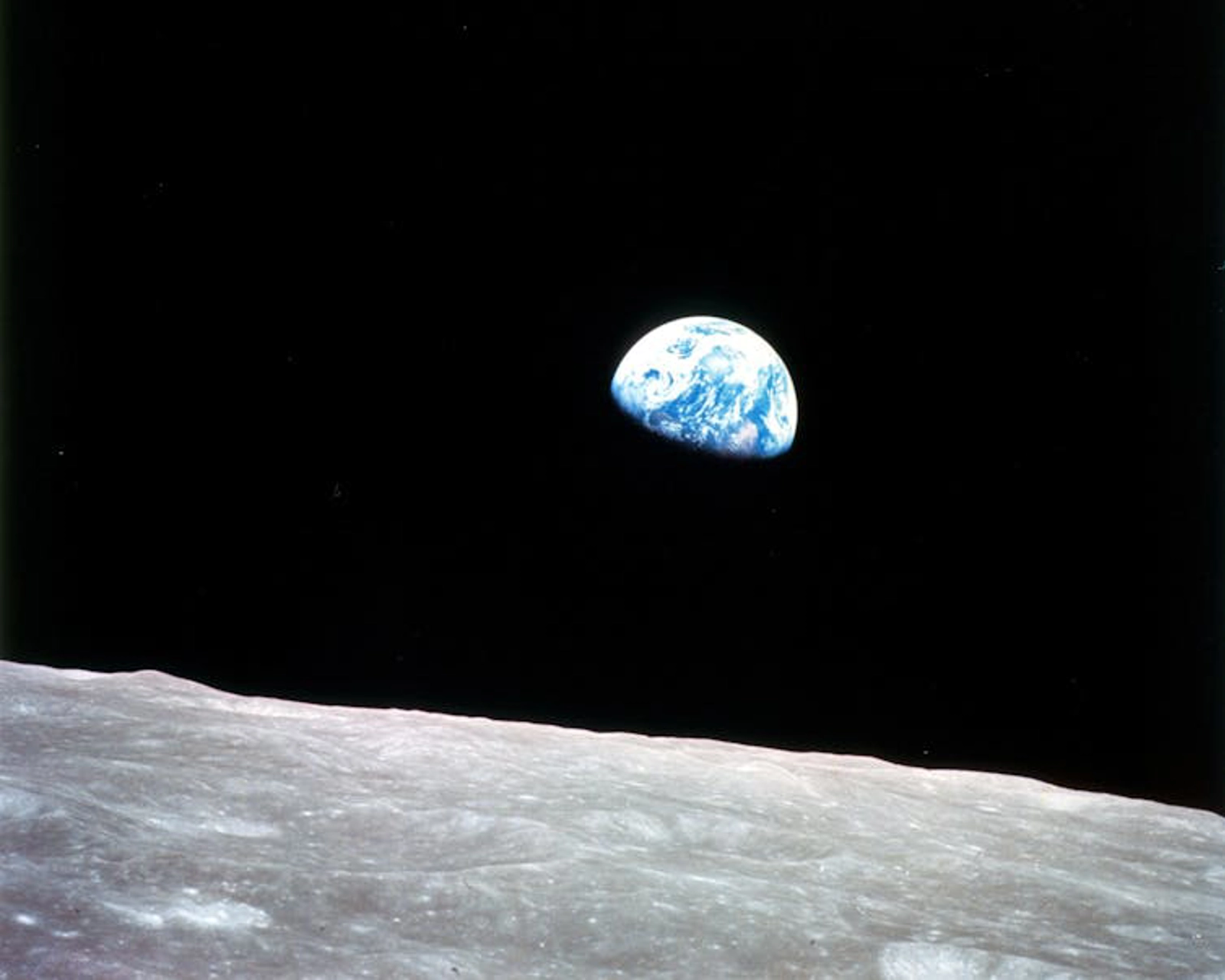 This photo of Earth, seen rising over the lunar horizon, was taken by the Apollo 8 crew on Christmas Eve 1968.