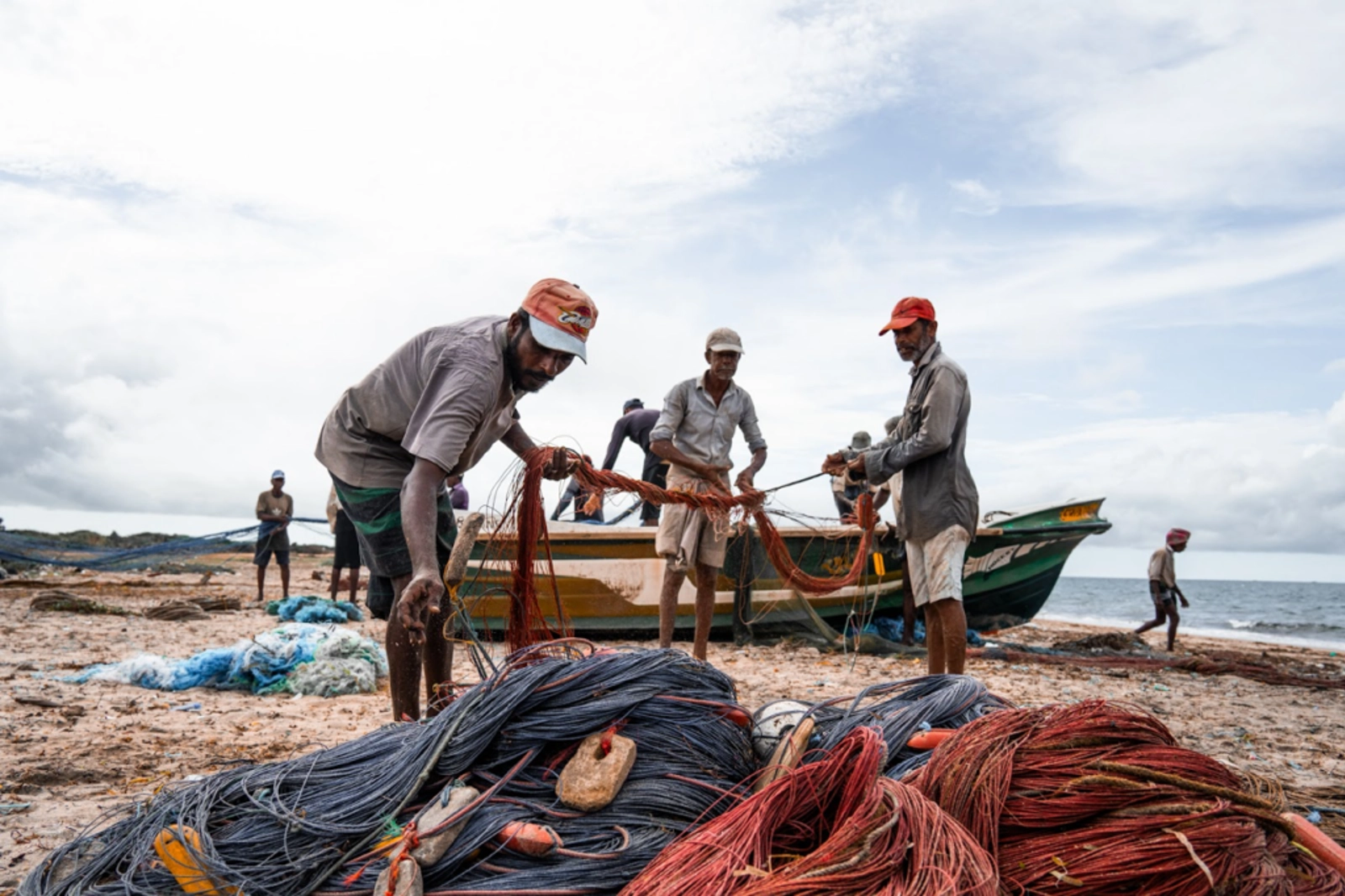 Traditional Artisanal fisherman in Mannar, Sri Lanka roll up their nets after the morning's hard work. Photo Credit: Marla Tomorug