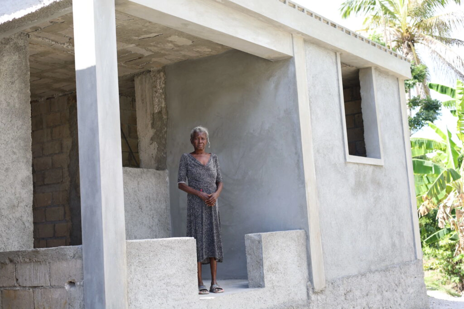 Sylviana Plaisimond standing in new housing in Haiti. Image: Build Change.