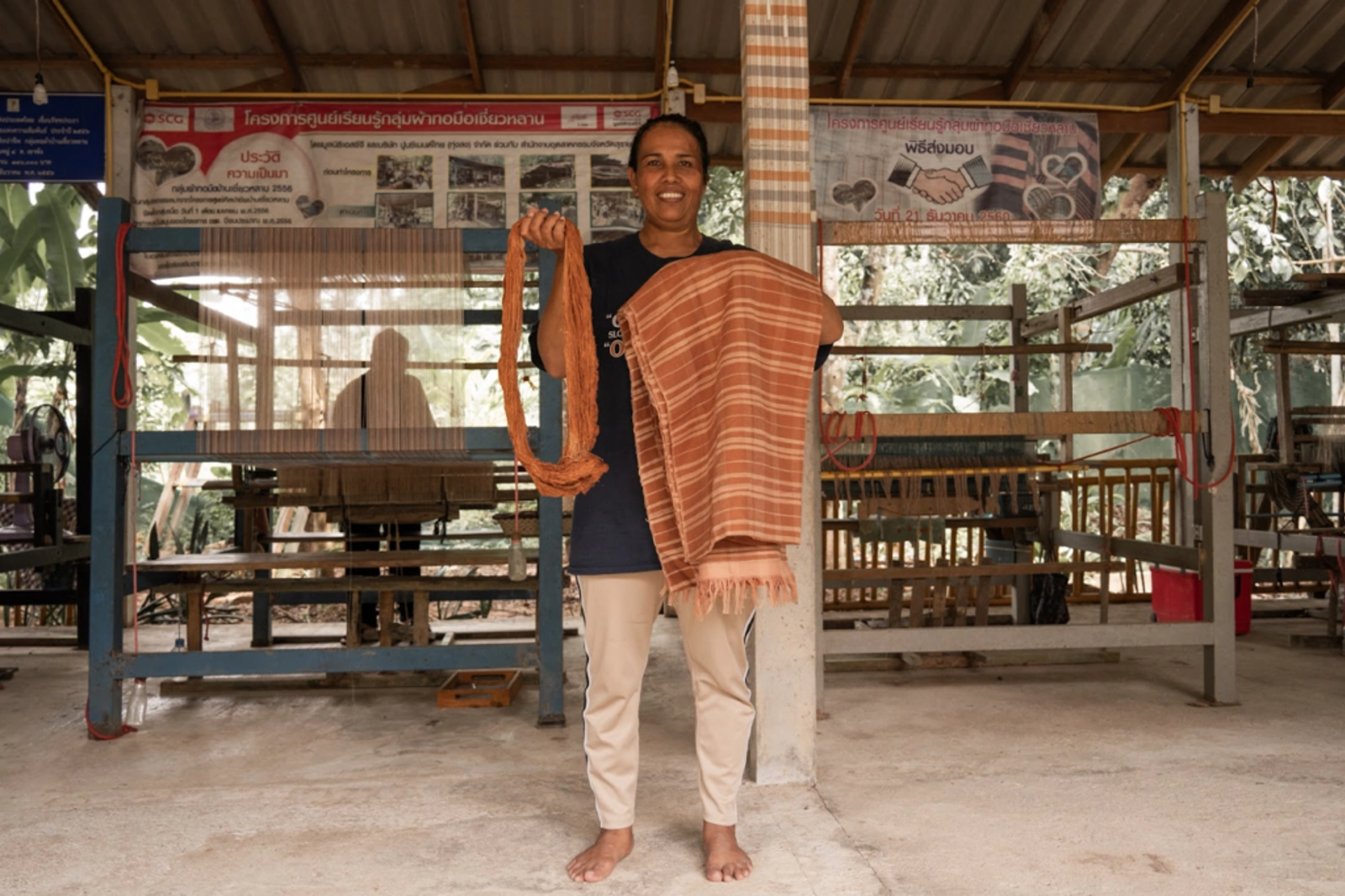 Chuen sharing her weaving at her textiles business. Photo Credit: Marla Tomorug.